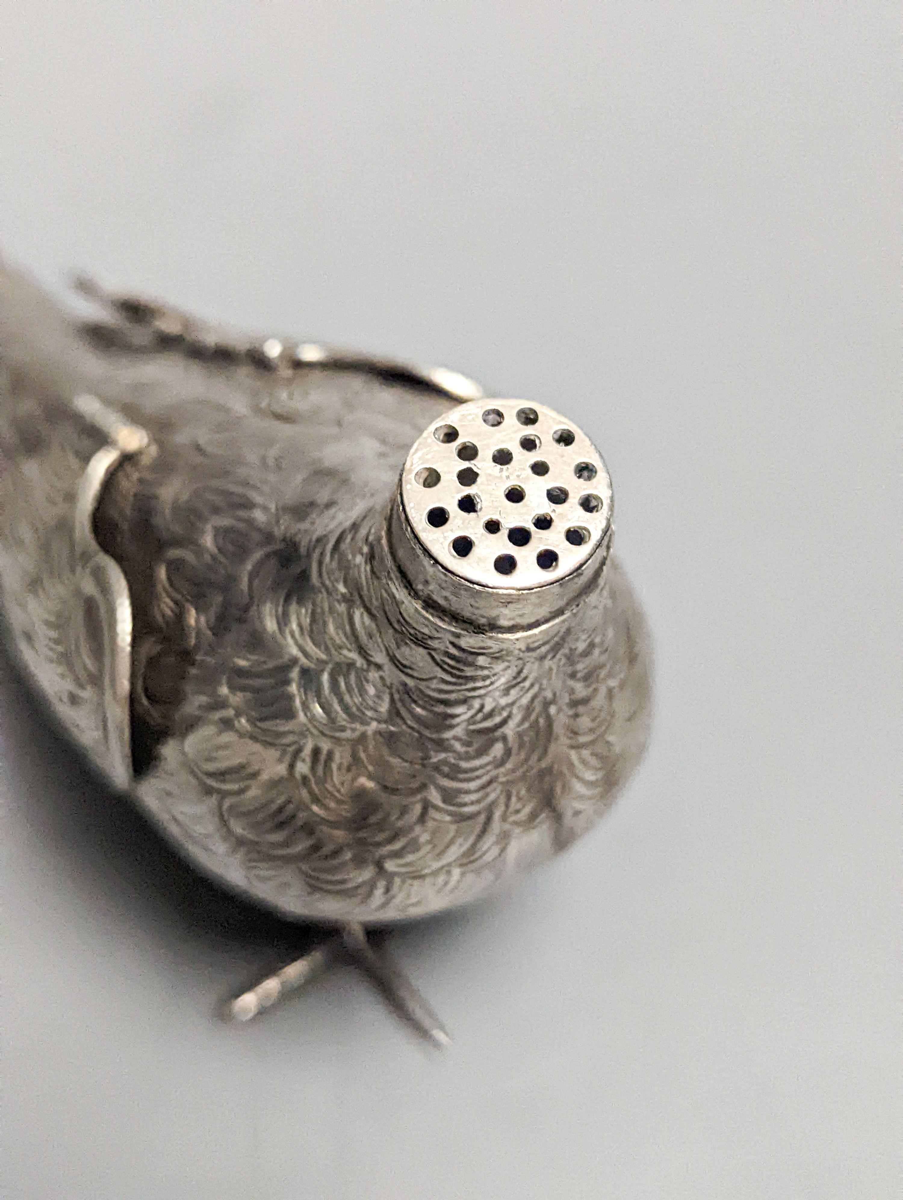 A late 19th century Hanau 800 white metal novelty condiment?, modelled as a game bird, with articulated wings and removable head, 22.4cm, gross 139 grams.